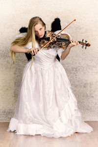 Portrait of woman in costume playing violin