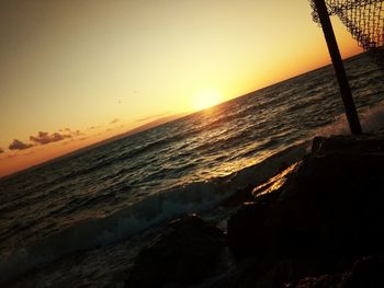 Scenic view of beach against sky during sunset