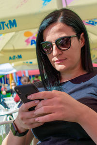 Woman using mobile phone outdoors