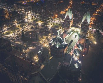 High angle view of illuminated buildings in city at night