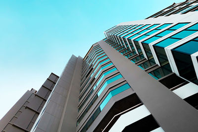 Low angle view of modern building against clear blue sky