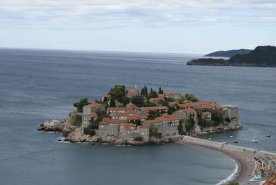 High angle view of sea and buildings against sky