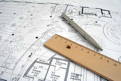 Close-up of pen and ruler on blueprint