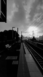 Railroad tracks in city against sky