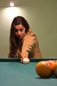 Young woman playing snooker