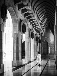 Full length rear view of man visiting mosque against clear sky