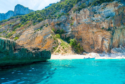 Scenic view of sea by rock formation