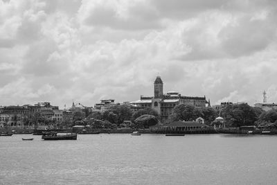 View of cityscape against cloudy sky