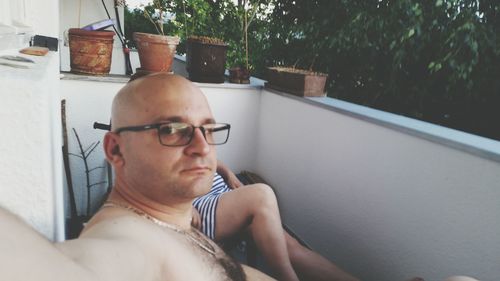Mid adult man sitting in balcony