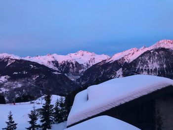 Scenic view of snowcapped mountains against blue sky