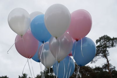 Low angle view of balloons against sky