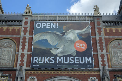 Low angle view of information sign against building