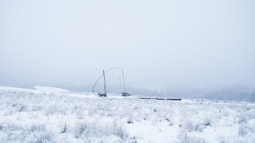 Scenic view of snow covered field against sky