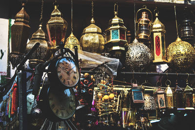 Illuminated lanterns hanging at market stall