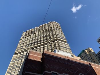 Low angle view of modern building against clear blue sky