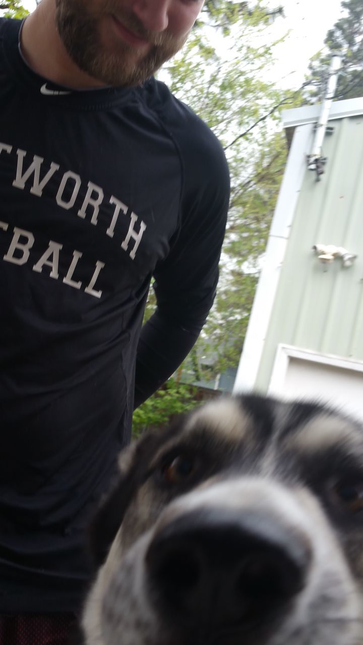 YOUNG MAN HOLDING DOG