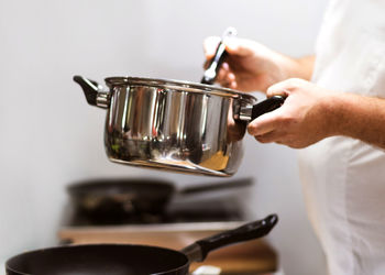 Midsection of man preparing food in kitchen