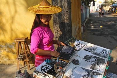 Woman holding umbrella standing at market