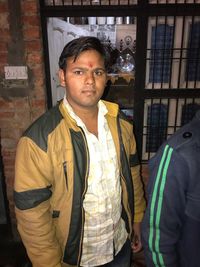 Portrait of young man standing outdoors