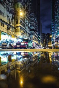 Illuminated city street and buildings at night