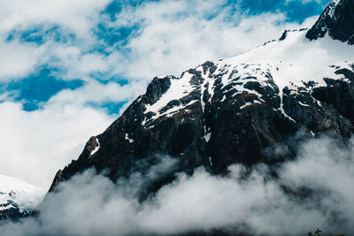 Low angle view of snowcapped mountain against sky