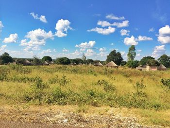 Scenic view of field against cloudy sky