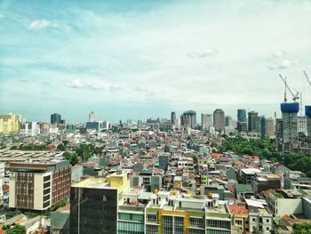 High angle view of buildings in city against sky