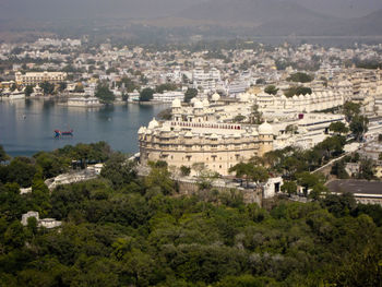 High angle view of buildings and trees in city