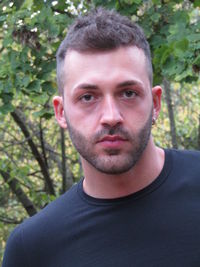 Portrait of young man against trees