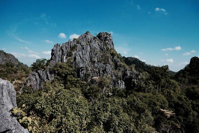 Low angle view of rocks on mountain against sky