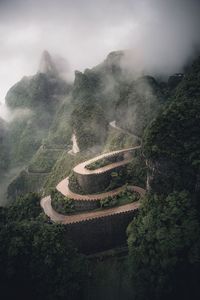 Scenic view of curvy road on mountain against sky