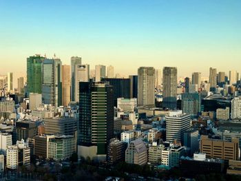 Modern buildings in city against clear sky