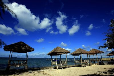 Gazebos at beach against sky