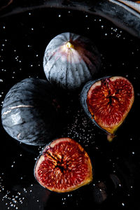 High angle view of fruits on black background