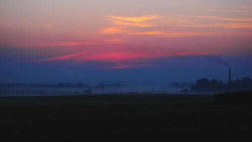 Silhouette landscape against scenic sky