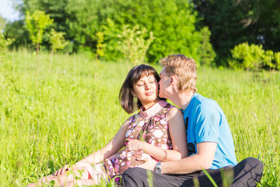 Happy couple sitting on grass