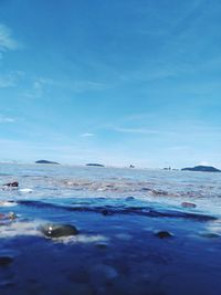 Scenic view of sea against blue sky