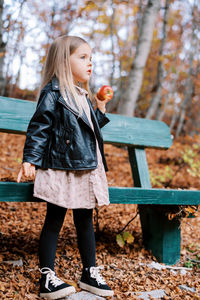 Portrait of young woman sitting on bench