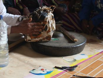 Low section of person sitting on table