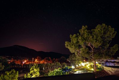 Illuminated buildings against sky at night