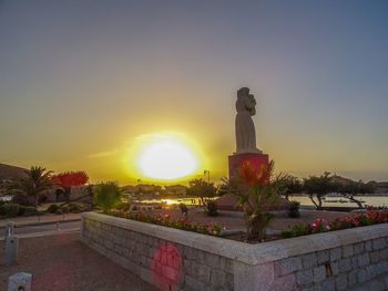 Statue against sky during sunset