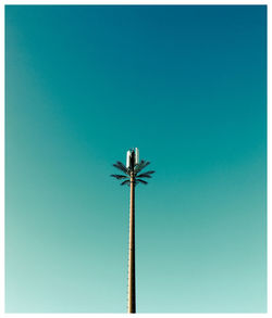 Low angle view of floodlight against clear blue sky