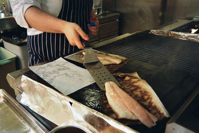 Midsection of woman preparing food