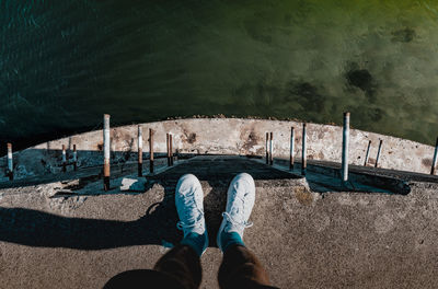 Low section of person standing on shore