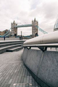 View of bridge over river against cloudy sky