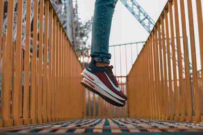 Low section of person standing on railing