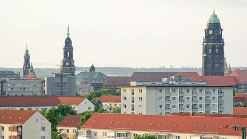 Buildings in city against clear sky