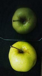 Close-up of apple against green background