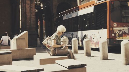 Full length of man sitting on seat