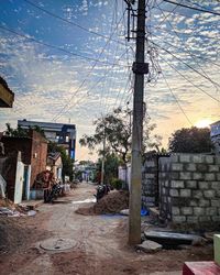 Street by buildings against sky